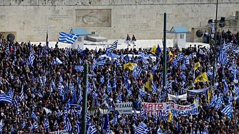 FILE: People with Greek flags attend a rally in front of the Tomb of the Unknown Soldier in Athens, Sunday, Feb. 4, 2018.