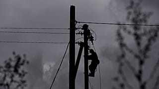 A worker climbs a utility pole while repairing power lines damaged in a Russian attack, Thursday, Oct. 16, 2025, in Shostka, Ukraine. 