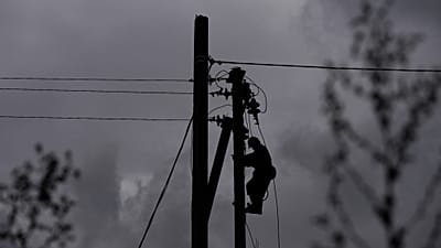 A worker climbs a utility pole while repairing power lines damaged in a Russian attack, Thursday, Oct. 16, 2025, in Shostka, Ukraine. 