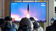 A TV screen shows a file image of North Korea's missile launch during a news program at Seoul Railway Station in Seoul, South Korea, Wednesday, Oct. 22, 2025. (AP Photo/Ahn Yo