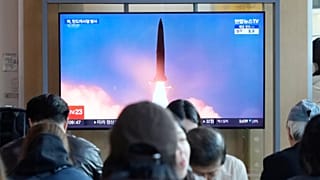 A TV screen shows a file image of North Korea's missile launch during a news program at Seoul Railway Station in Seoul, South Korea, Wednesday, Oct. 22, 2025. (AP Photo/Ahn Yo