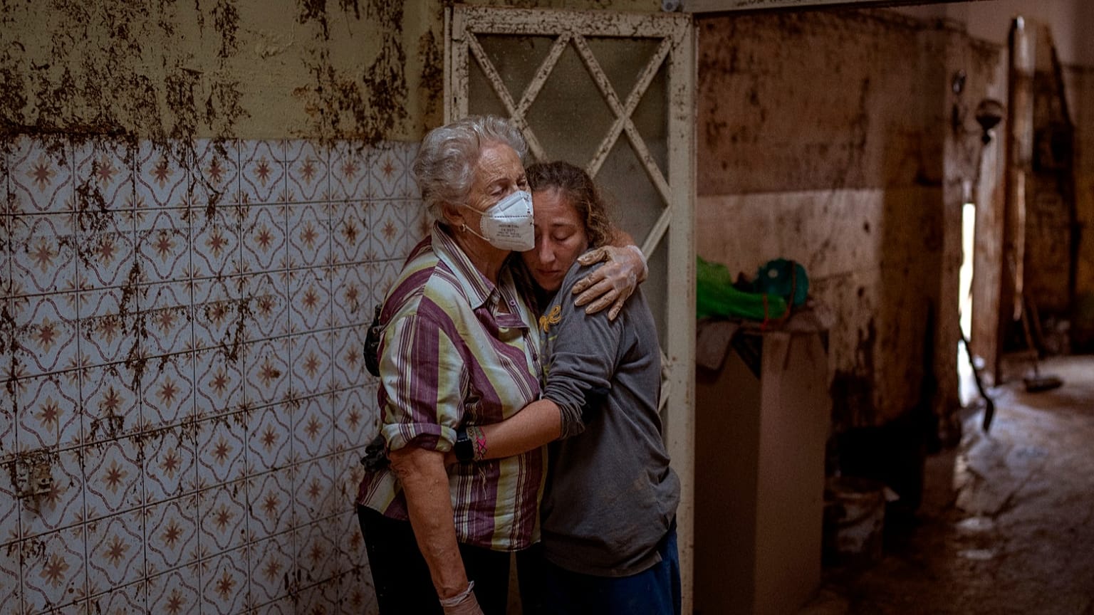 Vero Almarche hugs her neighbor María Muñoz after their house was destroyed by flooding in Masanasa, Valencia, Spain, Wednesday, Nov. 6, 2024.
