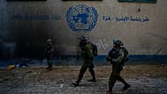 Israeli soldiers take position as they enter the UNRWA headquarters during a ground operation in Gaza, 8 February, 2024