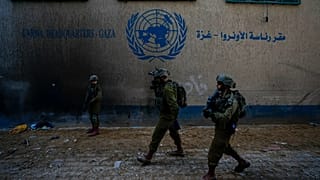 Israeli soldiers take position as they enter the UNRWA headquarters during a ground operation in Gaza, 8 February, 2024