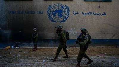 Israeli soldiers take position as they enter the UNRWA headquarters during a ground operation in Gaza, 8 February, 2024