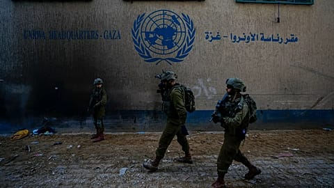 Israeli soldiers take position as they enter the UNRWA headquarters during a ground operation in Gaza, 8 February, 2024