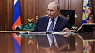 Vladimir Putin listens to the head of the Federal Service for Supervision of Natural at the Kremlin in Moscow, Russia, Oct. 21, 2025