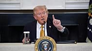 Donald Trump answers questions from reporters during a roundtable on criminal cartels in the State Dining Room of the White House, Thursday, Oct. 23, 2025.