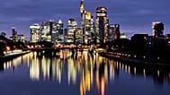 FILE. The buildings of the banking district are reflected in the river Main in Frankfurt, Germany. 16 Oct. 2025.