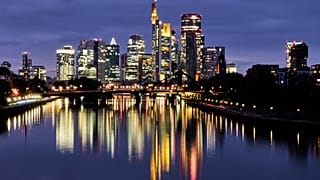 FILE. The buildings of the banking district are reflected in the river Main in Frankfurt, Germany. 16 Oct. 2025.