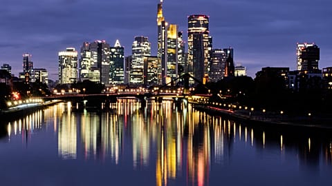 FILE. The buildings of the banking district are reflected in the river Main in Frankfurt, Germany. 16 Oct. 2025.