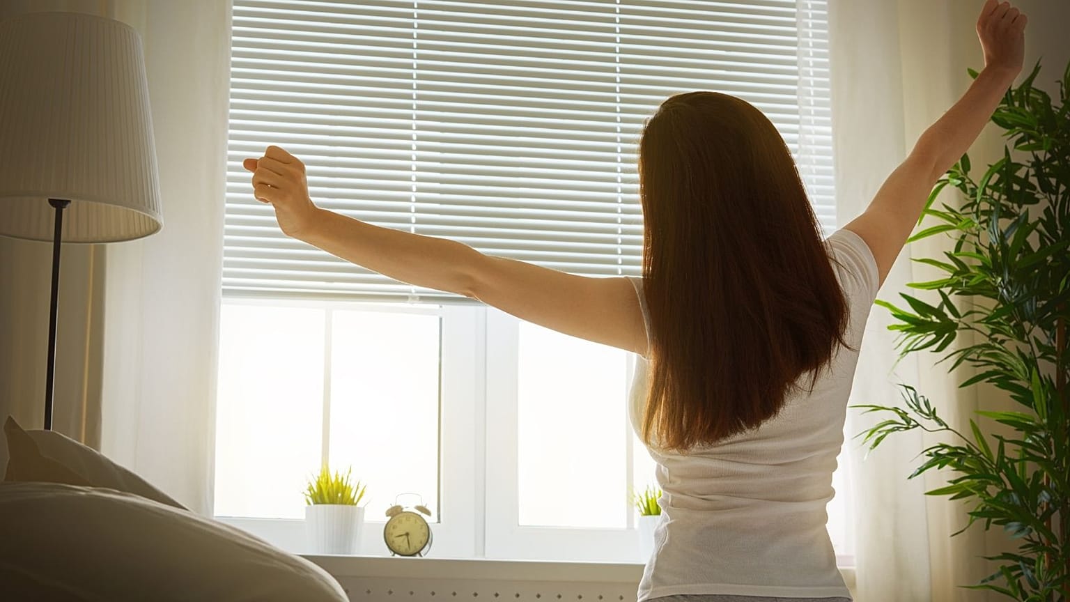 A woman stretches in the morning.