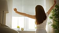 A woman stretches in the morning.