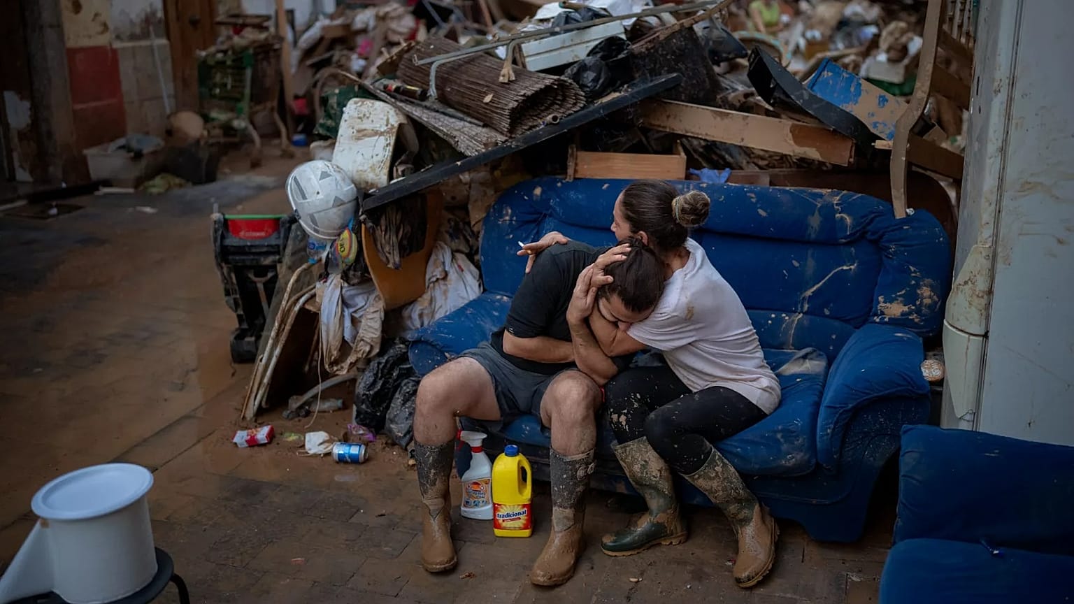 Tania hugs her brother-in-law Baruc after rescuing some of their belongings from their flooded house after the floods in Paiporta, 5 November, 2024