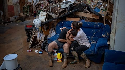 Tania hugs her brother-in-law Baruc after rescuing some of their belongings from their flooded house after the floods in Paiporta, 5 November, 2024