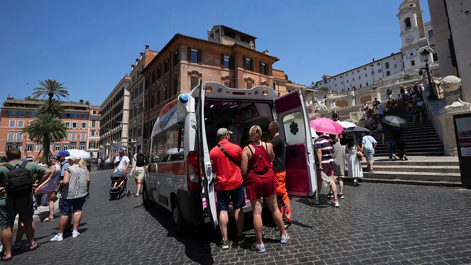 Paramedics provide aid to tourists and residents with an ambulance, next to the historical Spanish Steps, in Rome, Italy,  Photo by Andrew Medichini