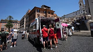 Paramedics provide aid to tourists and residents with an ambulance, next to the historical Spanish Steps, in Rome, Italy,  Photo by Andrew Medichini 