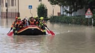 Firefighters use a dingy boat to evacuate civilians after flooding in Faenza, in the region of Emilia Romagna, Italy, Thursday, Sept. 19, 2024.