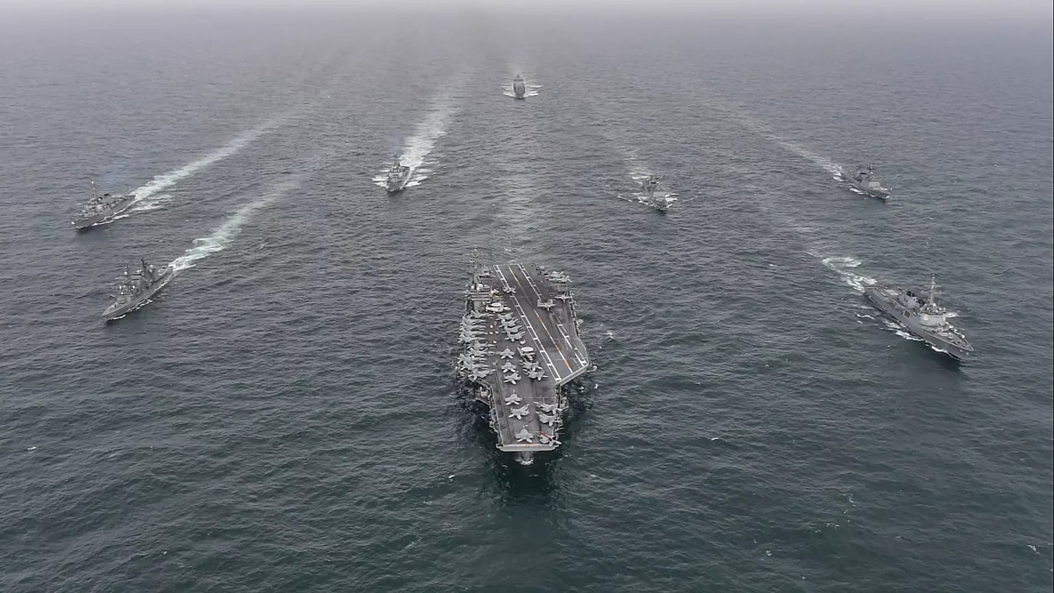 The US Navy's aircraft carrier USS Nimitz, centre, in international waters off South Korea, 4 April, 2023