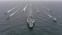 The US Navy's aircraft carrier USS Nimitz, centre, in international waters off South Korea, 4 April, 2023