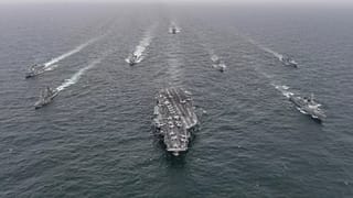 The US Navy's aircraft carrier USS Nimitz, centre, in international waters off South Korea, 4 April, 2023