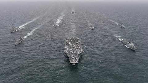 The US Navy's aircraft carrier USS Nimitz, centre, in international waters off South Korea, 4 April, 2023