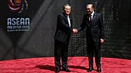 China's Premier Li Qiang, left, shakes hands with Malaysia's Prime Minister Anwar Ibrahim as he arrives at the Kuala Lumpur Convention Centre,  Monday, Oct. 27, 2025.