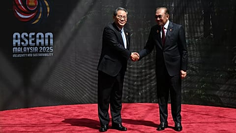 Çin Başbakanı Li Qiang, solda, 27 Ekim 2025, Pazartesi günü Kuala Lumpur Kongre Merkezi'ne gelişinde Malezya Başbakanı Anwar İbrahim ile el sıkışıyor. 