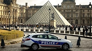 A police car parks in the courtyard of the Louvre museum, one week after the robbery, Sunday, Oct. 26, 2025 in Paris, France.