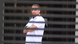 Brazil's former President Jair Bolsonaro stands at the entrance of his home where he is under house arrest in Brasilia, 2 September, 2025
