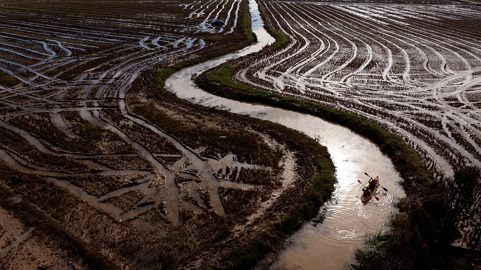 Members of a military emergency unit use a canoe to search the area for bodies washed away by floods in the outskirts of Valencia, Spain, 8 November, 2024
