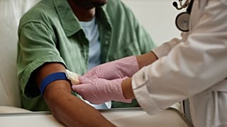 A man prepares to undergo a blood test.