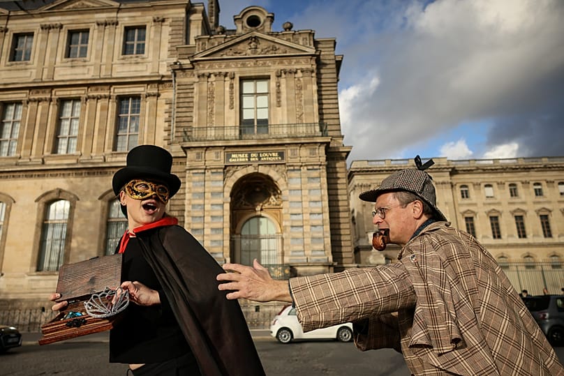 Members of the Paris Holmes Society reenact the theft by the window where thieves entered the Louvre museum, 25 October, 2025