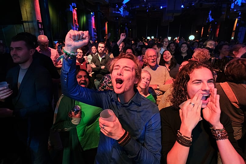 People react during early exit poll results for the PvdA party at an election venue during a general election in Rotterdam