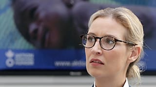 FILE - In this Aug. 21, 2017 file photo, Alice Weidel, co-top candidate of the German AfD party for the upcoming general elections, sits in front of a screen.