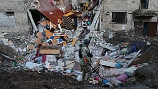 Emergency personnel examine the site of an airstrike after a Russian missile hit a hostel in Zaporizhzhia, 30 October, 2025