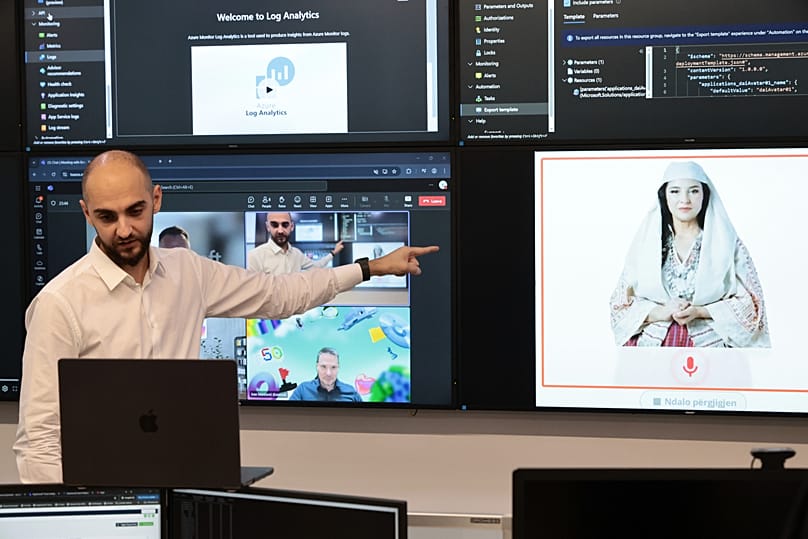 Enio Kaso, head of the Department of Artificial Intelligence and Cryptocurrency Licensing shows the AI "minister" Diella, during a conference