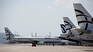An Aegean Airlines plane approaching the terminal as others planes are parked at Eleftherios Venizelos International Airport in Athens, 31 March, 2020