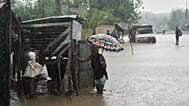 Residents wade through a flooded street in the aftermath of Hurricane Melissa in Petit-Goave, Haiti