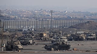 FILE: Israeli tanks are parked in a staging area near the border with Gaza, in southern Israel, 29 October 2025