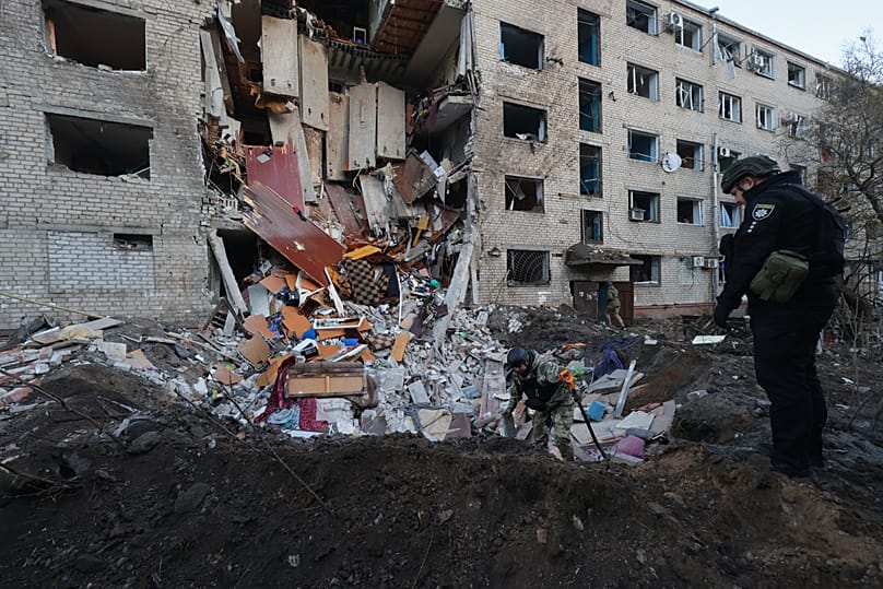 Emergency personnel examine the site of an airstrike after a Russian missile hit a hostel in Zaporizhzhia, 30 October, 2025