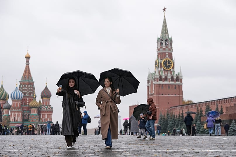People walk in the rain through Red Square in Moscow, 17 October, 2025
