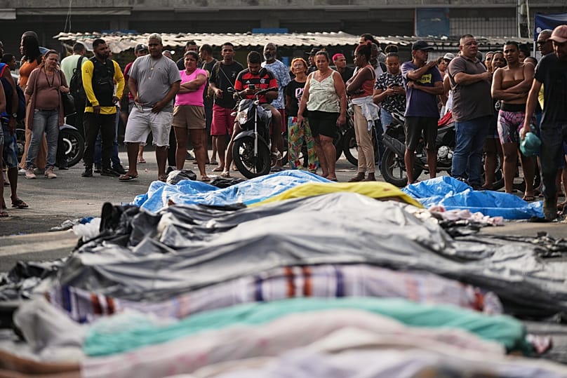 Residents look at the bodies of people killed the day before during a police raid targeting the Comando Vermelho gang in Rio de Janeiro, 29 October, 2025