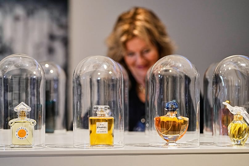 A woman smells perfume samples during the exhibition "The Secret Power of Scents",
