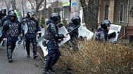 Riot police walk to block demonstrators during a protest in Almaty, 5 January, 2022