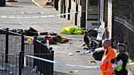Belongings of escaping passengers are seen on the ground at the entrance to the train station after a mass stabbing on a London-bound train in Huntingdon, England