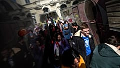Украинские беженцы готовятся к посадке в автобусы, отправляющиеся в Италию, в Пшемысле, Польша (23 марта 2022 года)