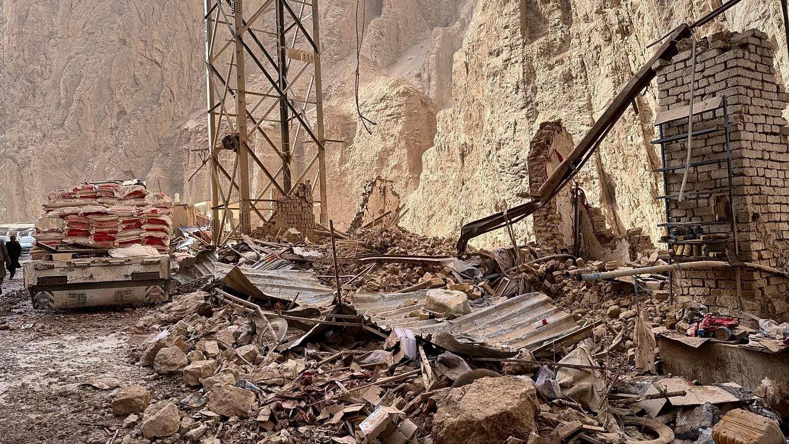 Damage is seen along a road near the site of a powerful 6.3-magnitude earthquake in a rural area of the Khulm District