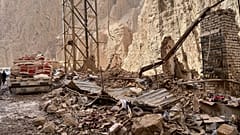 Damage is seen along a road near the site of a powerful 6.3-magnitude earthquake in a rural area of the Khulm District