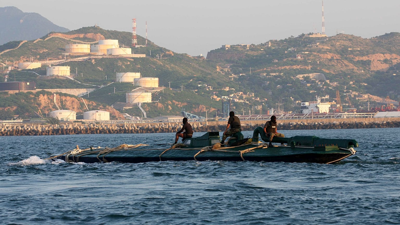 FILE: Navy sailors ride atop a 10-metre submarine packed with more than 5 tonnes of cocaine, as it is being towed into the port of Salina Cruz, Mexico, 18 July 2008